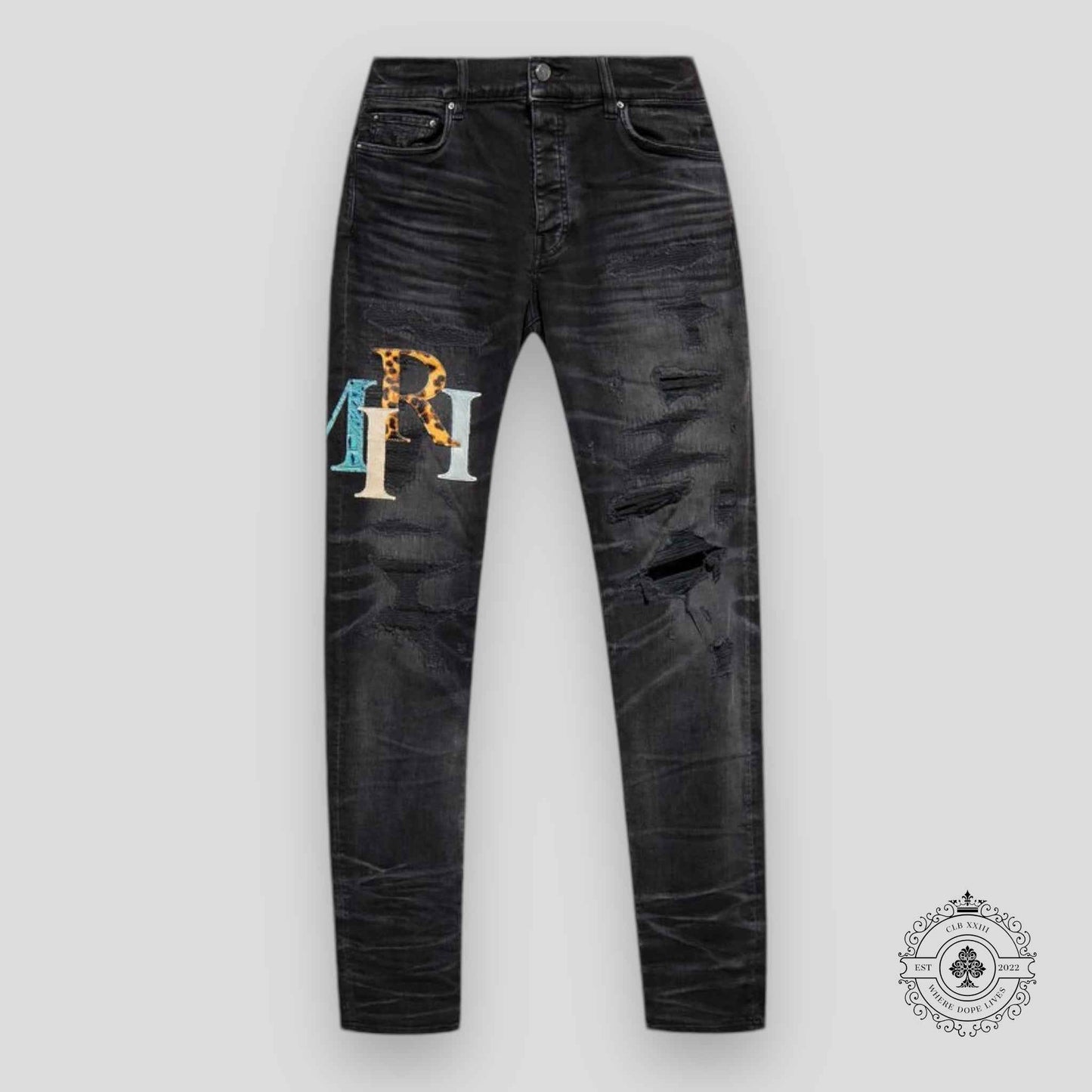 Amiri Staggered Logo Denim Jeans in Black