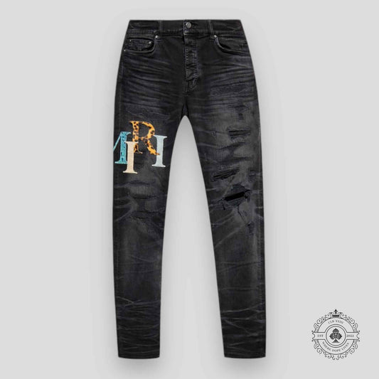 Amiri Staggered Logo Denim Jeans in Black