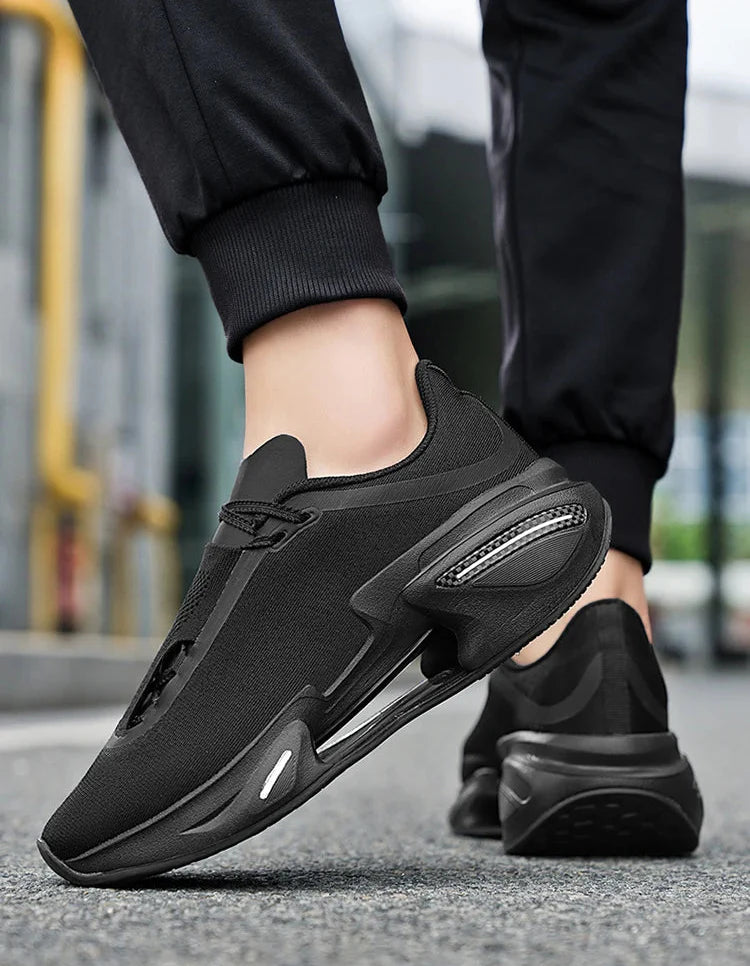 Black athletic shoes worn by a person on a blurred street background