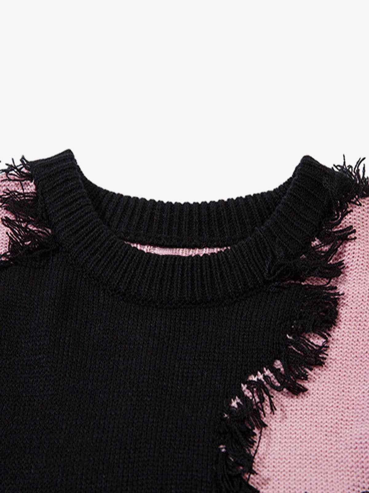 Front view of model wearing grey oversized raw edge fringed knit sweater