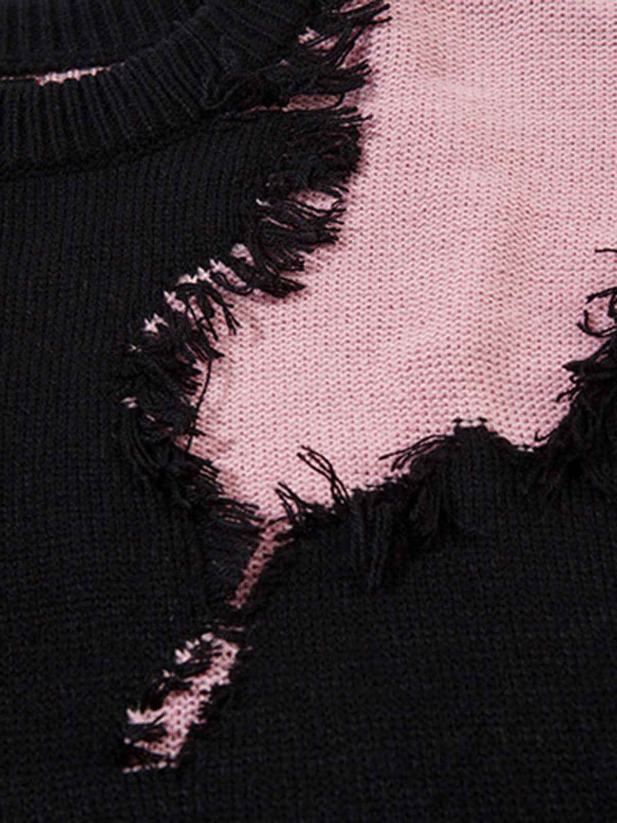 Front view of model wearing grey oversized raw edge fringed knit sweater